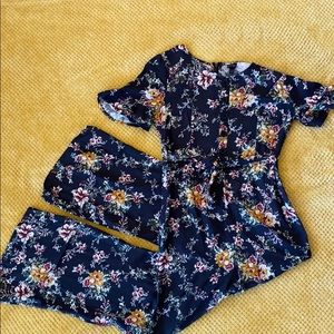 Girls belted dark gray and floral pant romper.